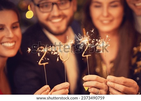 Two beautiful young couples having fun at New Year's Eve Party Royalty-Free Stock Photo #2373490759