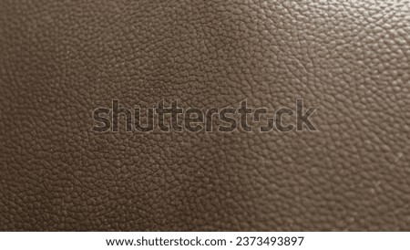 Close up look of a dark brown leather material
