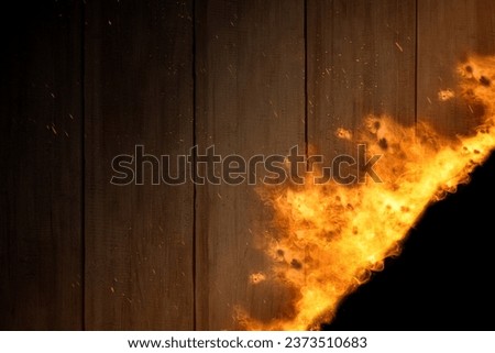 Wooden wall with fire flame on a dark background. Scary Halloween background concept