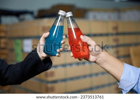 closeup worker holding basil seed drink in the beverage factory Royalty-Free Stock Photo #2373513761