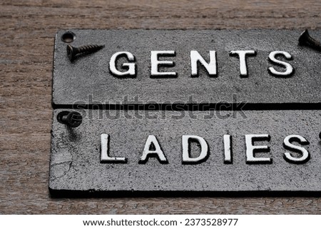 Restroom sign on wooden table