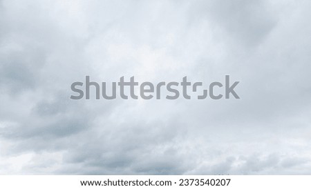 Autumn brings overcast skies adorned with gray stratus clouds, hinting at impending rain. This full-screen view provides ample space for text or design elements, making it perfect for various projects Royalty-Free Stock Photo #2373540207