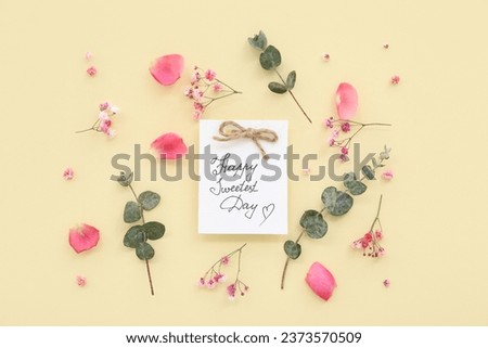 Greeting card with text HAPPY SWEETEST DAY and rose flowers on yellow background. National Sweetest Day Royalty-Free Stock Photo #2373570509