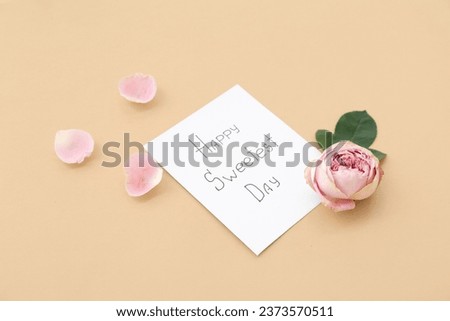 Greeting card with text HAPPY SWEETEST DAY and rose flower on beige background. National Sweetest Day Royalty-Free Stock Photo #2373570511
