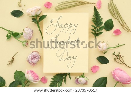 Greeting card with text HAPPY SWEETEST DAY and rose flowers on yellow background. National Sweetest Day Royalty-Free Stock Photo #2373570517