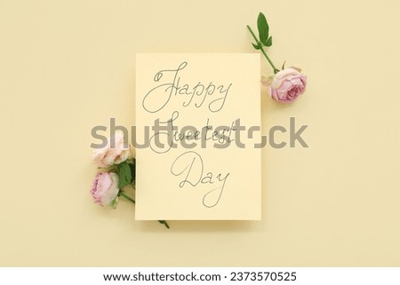 Greeting card with text HAPPY SWEETEST DAY and rose flowers on yellow background. National Sweetest Day Royalty-Free Stock Photo #2373570525