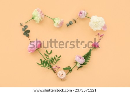Heart made from flowers on beige background. National Sweetest Day Royalty-Free Stock Photo #2373571121