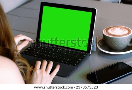 Woman long hair using laptop show blank screen monitor at coffee shop, online working from home concept.