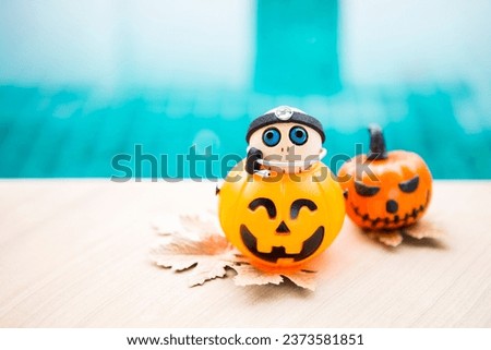 Little doctor ghost wooden doll in Halloween lantern on swimming pool edge, outdoor day light, Halloween background idea