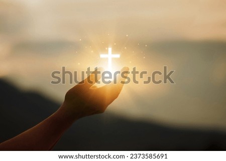 Human hands open palms up to worship hope with the Cross is a symbol of Christianity.Concept Religion and spirituality with believe Power of hope or love and devotion. fighting and victory for god.  Royalty-Free Stock Photo #2373585691