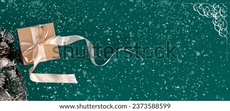 A Christmas gift on an emerald background. Christmas banner.Minimalism. Copyspace.
