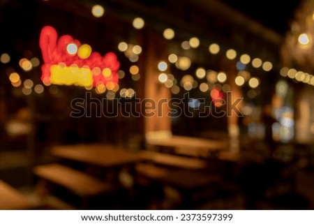 blurred defocused bokeh lights from restaurant in the city at night, abstract colourful background.