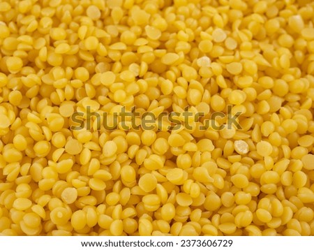 background of yellow pearls of natural beeswax Royalty-Free Stock Photo #2373606729