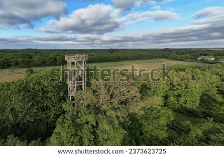 An aerial shot of the watchtower Belvedere near the city Heerenveen under cloudy sky