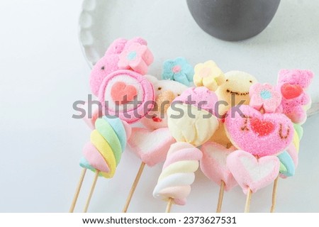 Super cute cartoon marshmallows on a stick, colorful, beautiful, sweet, delicious, chewy for celebration. on a white background