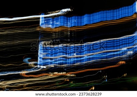 Abstract. Multicolored lines from long exposure. Colored background. Night city concept. Colorful light trails on dark with motion blur effect of long time exposure