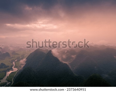 Aerial view of dawn on mountain at Ngoc Con ward, Trung Khanh town, Cao Bang province, Vietnam with river, nature, green rice fields. Near Ban Gioc waterfall. Travel and landscape concept.