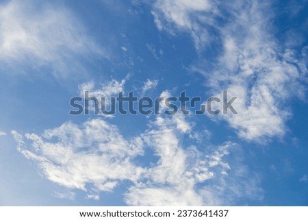 Blue sky with fluffy clouds; soft white clouds on blue sky. Skyscraper background.