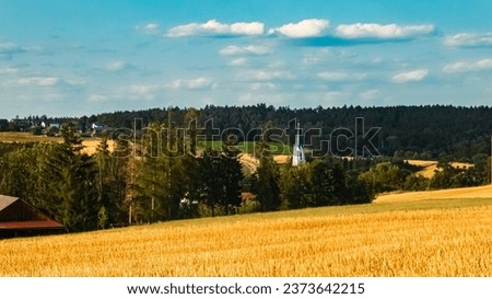 Agricultural summer view with a church near Ottering, Moosthenning, Dingolfing-Landau, Bavaria, Germany