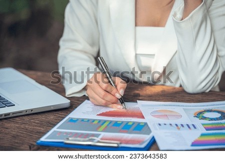 Hand woman and measuring tool work on table with many data analyst statistics drawing graph analytics diagram work paper for best solution to explaining Business feasibility increase sales profit