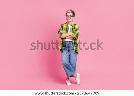 Full length photo of thoughtful minded woman wear checkered shirt look at offer empty space hand on chin isolated on pink color background