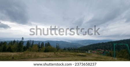 Autumn brings overcast skies adorned with gray stratus clouds, hinting at impending rain. This full-screen view provides ample space for text or design elements, making it perfect for various projects Royalty-Free Stock Photo #2373658237