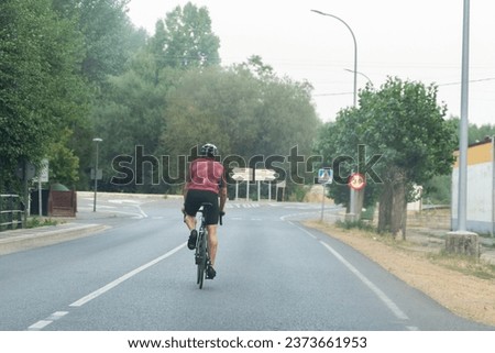 cyclist looking at road signs an adult male cyclist Royalty-Free Stock Photo #2373661953