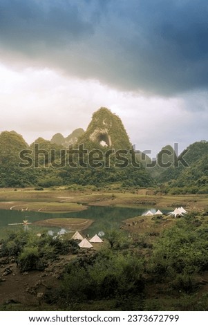 Aerial view of Thung mountain in Tra Linh, Cao Bang province, Vietnam with lake, cloudy, nature. Travel and landscape concept.