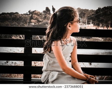 Ai photo simple concept idea with editing raw filter effect.Little girl wearing black eyeglass.White color cloth and hand sitting near pond.