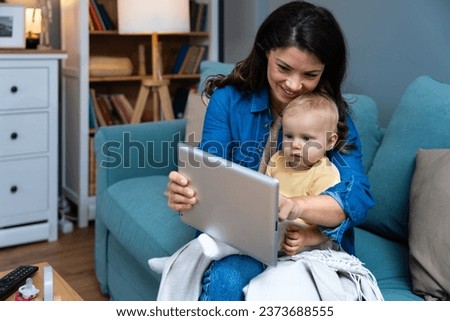 Mother, baby and tablet on sofa watching educational video online on streaming service in home. Love, family time and woman with girl child smile on couch to watch kids movie or cartoon on website.