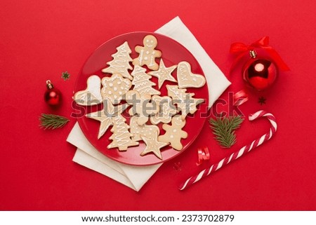 Cute homemade Christmas cookies with decor on color background,top view
