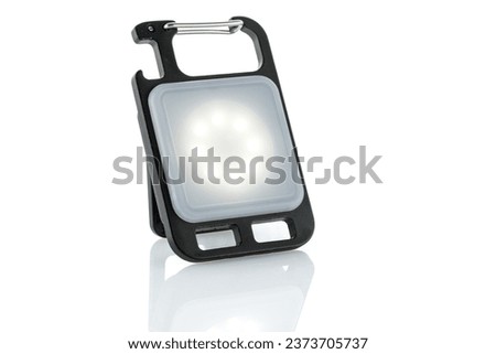 Mini LED flashlight for camping and other night outdoor activities isolated on white background. Close up