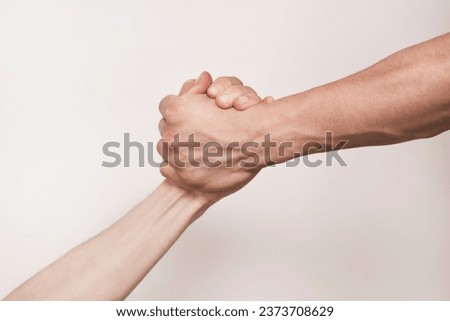 The concept of support and mutual understanding, helping one's neighbor, two hands holding each other, the stronger hand holding the weaker one and helping in trouble Royalty-Free Stock Photo #2373708629