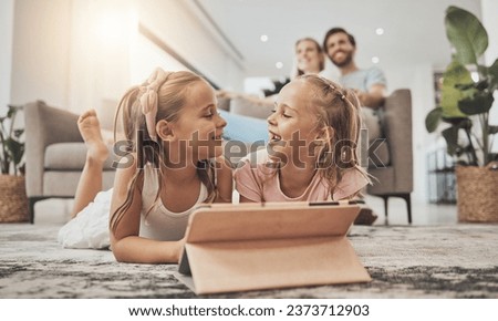 Kids on floor of living room with tablet, smile and watching video, movie streaming and technology. Digital games, online app and happy girl children relax on carpet together with fun in family home.
