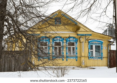 A Russian wood house covered in snow