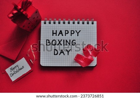 happy boxing day - red christmas background with card and gift 