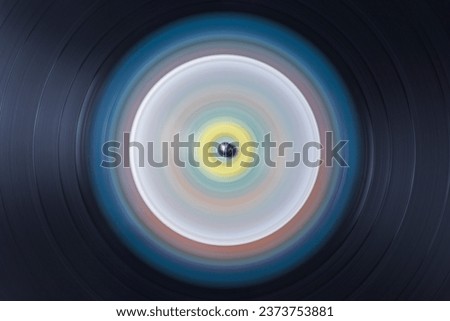 Detail of the microgrooves of an old vinyl record in motion