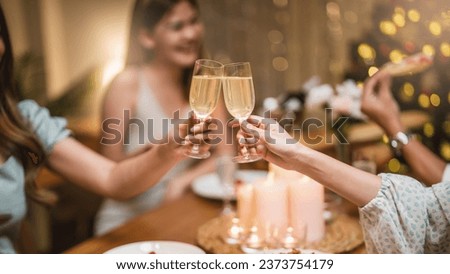 Closeup hands with glasses of champagne wine clink in christmas celebrate party festive Royalty-Free Stock Photo #2373754179