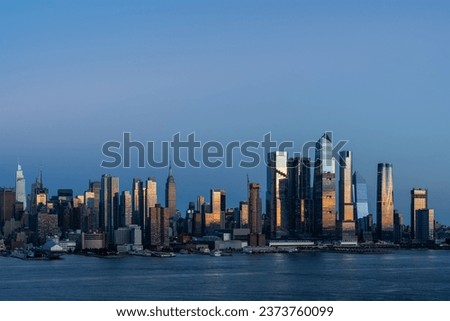 Aerial New York City skyline from New Jersey over the Hudson River with the skyscrapers of the Hudson Yards district at sunset. Manhattan, Midtown, NYC, USA. A vibrant business neighborhood Royalty-Free Stock Photo #2373760099