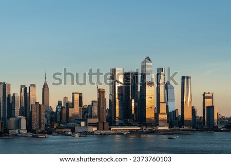 Aerial New York City skyline from New Jersey over the Hudson River with the skyscrapers of the Hudson Yards district at sunset. Manhattan, Midtown, NYC, USA. A vibrant business neighborhood Royalty-Free Stock Photo #2373760103