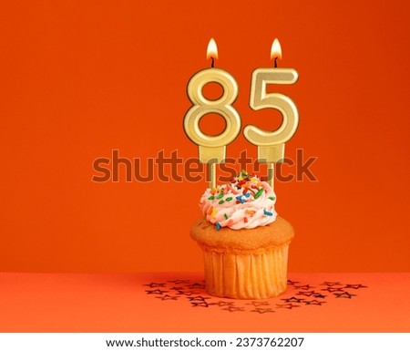Number 85 candle - Birthday card design in orange background Royalty-Free Stock Photo #2373762207