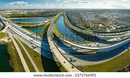 USA transportation infrastructure concept. Above view of wide highway crossroads in Miami, Florida with fast driving cars Royalty-Free Stock Photo #2373766901