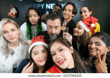 Let's take a selfie !! A group of diverse business people and colleagues having fun together at a business New Year party. A teamwork celebration of a successful.