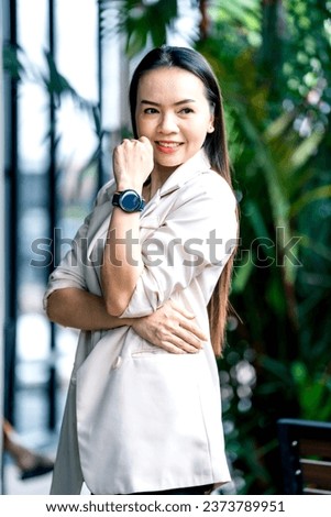 Portrait Asian businesswoman professional in grey business suit  on a cafe background.Business stock photo.
