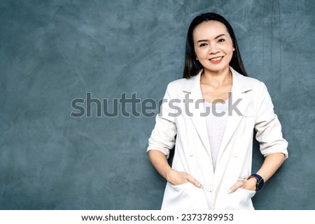 Portrait Asian businesswoman professional in grey business suit  on a gray background.Business stock photo.