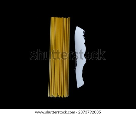 Dry or uncooked spaghetti noodles on black background