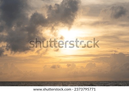 Sunset sky with clouds over the horizon over the sea, gloomy sky Royalty-Free Stock Photo #2373795771