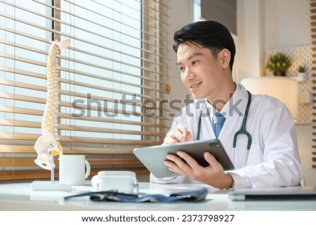 Young doctor using digital tablet checking on new pills online delivered to clinic. Medicine, technology and healthcare concept.