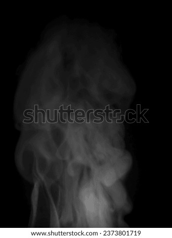 Abstract white puffs of smoke swirl overlay on black background pollution. Royalty high-quality free stock image of abstract smoke overlays on black Vertical backgrounds. White smoke swirls fragments