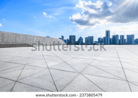 Empty square floors and urban residential area buildings under the blue sky